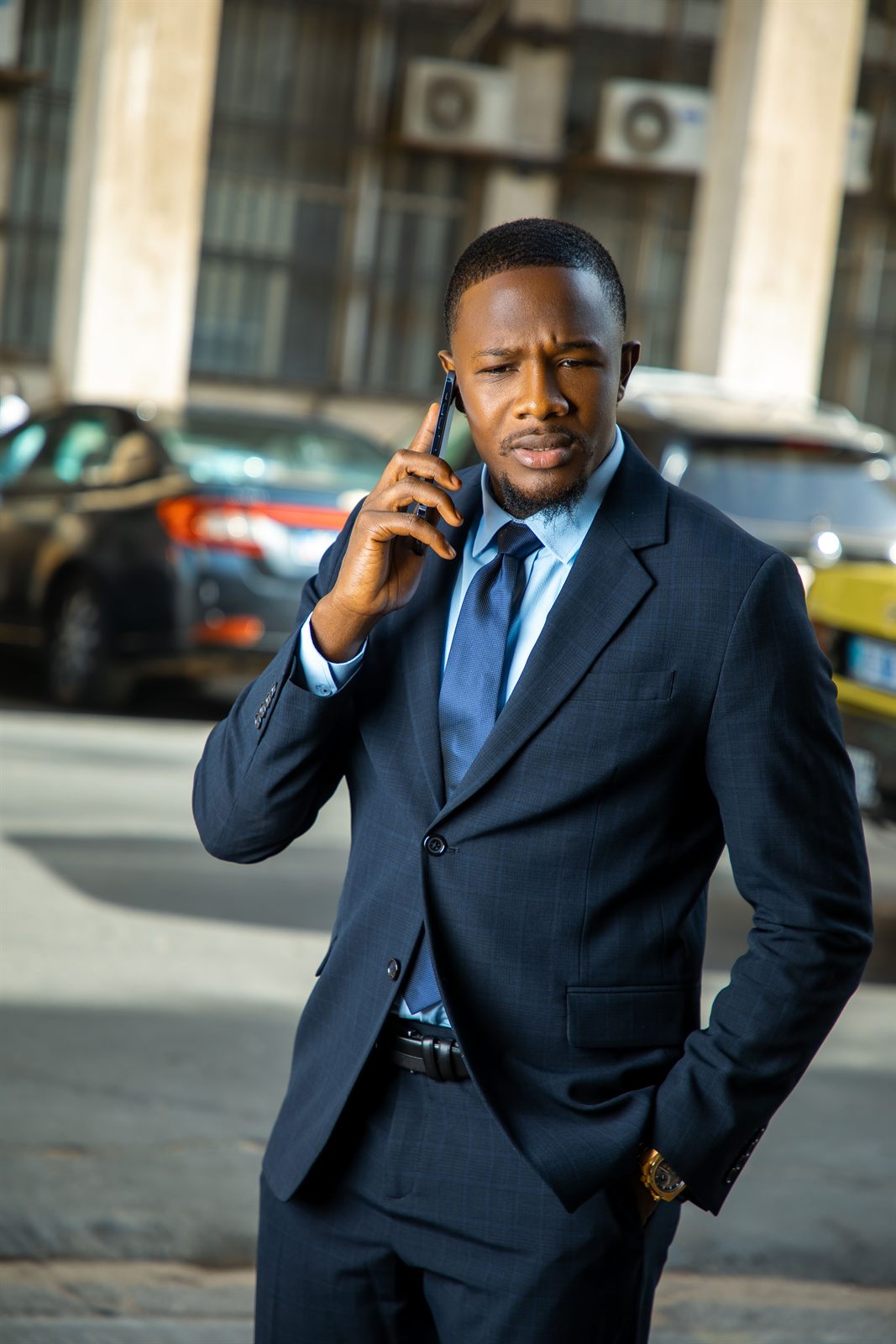 A Ugandan business owner taking a call outside the office
